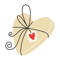 Heartshaped gift wrapped in beige paper with black ribbon and tag