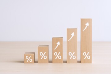Wooden Blocks Displaying Percentage Signs and Upward Arrows Symbolizing Growth and Financial Success