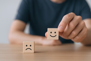 Customer Feedback: Hand Holding Happy Face Wooden Block, with Sad Face Block on Table