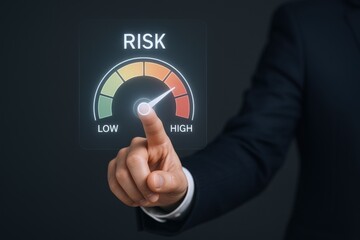 Assessing Investment Risk: Businessman's Hand Interacting with a Digital Risk Gauge Displaying Low to High