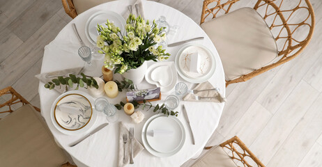 Beautiful table setting with eustoma flowers and candles for wedding celebration in room, top view