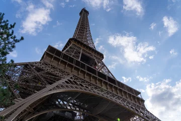 Ingelijste posters Eiffeltoren Eiffel Tower against a blue sky with clouds.  © porqueno