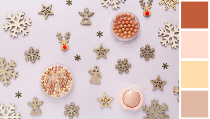 Beautiful Christmas composition with decorative snowflakes, highlighter and blush pearls on light...