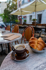 Coffee and croissants at an outdoor cafe.