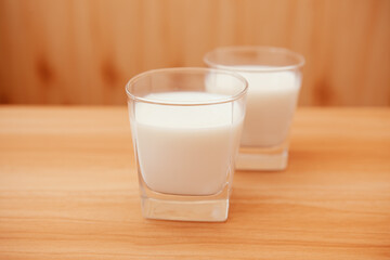 Two glasses of fresh white milk on the table on the kitchen