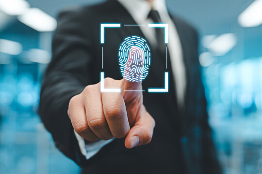 Businessman using fingerprint scan for secure access and identification in a modern office space - Powered by Adobe
