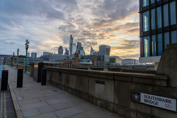 London skyline at sunrise viewed from Southwark Bridge