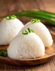 Three rice mounds on a wooden plate
