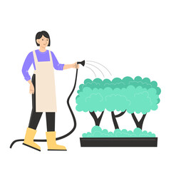 Person in apron watering trees with a hose
