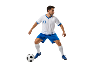 A male soccer player dribbles a soccer ball. The athlete, in a light blue and white uniform, has focused on the ball, showcasing skill and agility on the field. 