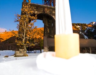 Snowy landscape with bridge and yellow object