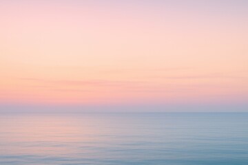 Vertical pastel sunrise gradient over calm sea with soft haze peaceful wallpaper