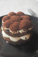 Delicious dessert served on a dark plate at a cafe