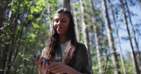 Exploring the forest with a young woman who enjoys nature and outdoor activities while appreciating the environment