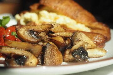 Breakfast plate with mushrooms and scrambled eggs served