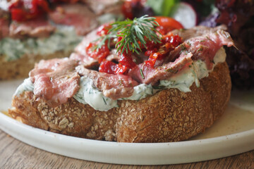 Delicious open-faced sandwich served on a wooden table