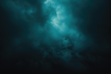 A dramatic view of dark, swirling clouds highlighted by a mystical teal light, creating an atmospheric and moody sky.