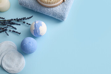 Composition with lavender bath bombs and reusable cotton pads on blue background, closeup