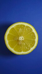 Vibrant yellow lemon slice on a blue background
