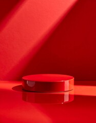 Red cylindrical podium with dramatic shadows