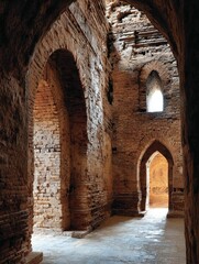Ancient arches and brickwork, sunlit passage