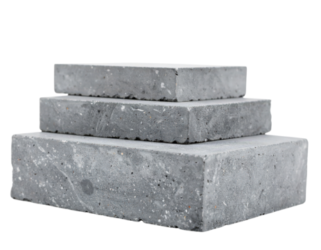 Three grey concrete construction blocks stacked in a pyramid shape.