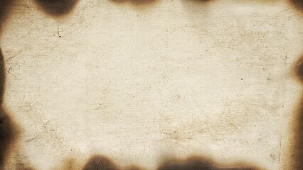 Textured vintage paper with burned borders and aged parchment look. Vintage textured paper background with scorched and weathered edges. Vintage paper with space for text or design.