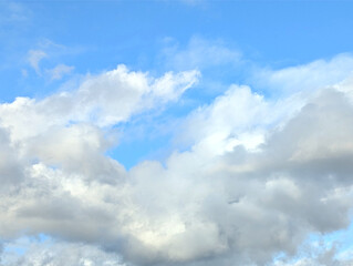 Clouds sky background. Fluffy clouds on a blue sky background