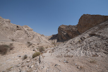 Scenic landscapes and mountain roads around Jebel Hafeet in Al Ain, United Arab Emirates, showing desert terrain, rocky hills, and winding routes under clear skies.
