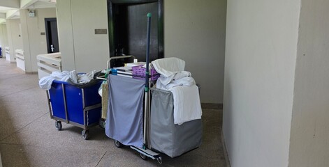 Hotel room cleaning cart with cleaning equipment and hotel amenities, room service