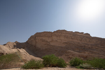Scenic landscapes and mountain roads around Jebel Hafeet in Al Ain, United Arab Emirates, showing desert terrain, rocky hills, and winding routes under clear skies.