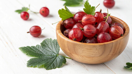 Red gooseberry in wooden bowl on white background