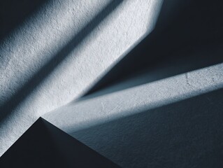 Abstract geometric background with textured rough surfaces. Diagonal light and shadow create minimalist lines and shapes, suitable for modern design concepts.
