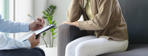 mental health treatment concept. Stressed asian patient talking with personal psychologist in therapist session have a burnout in work at clinic in office room.