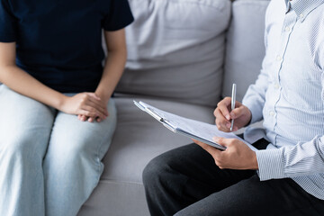 sad female sitting on sofa Patient discussing mental health issues with psychologist. depressed asian woman mental health treatment