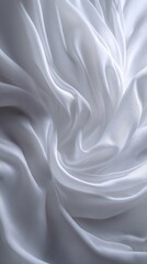 Elegant white fabric flowing in soft waves and textures.