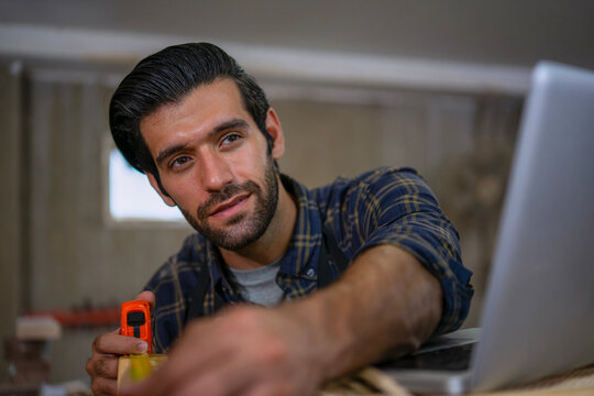 Carpenter is working at workshop.