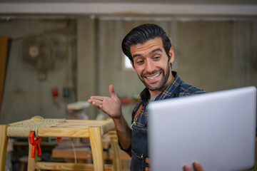 Carpenter is working at workshop.