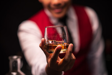 Bartender is pouring whiskey into a glass in a restaurant	
