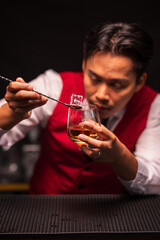 Bartender is pouring whiskey into a glass in a restaurant	