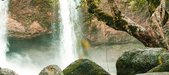 natural waterfall, rocks, green plants, water. mist, cool and calm, quiet and without anyone.
