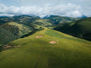 Aerial view of beautiful high altitude grassland mountains and forest landscape in China