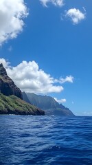 Dramatic Cliffs Meeting Deep Blue Ocean Under a Sunny Sky with Clouds