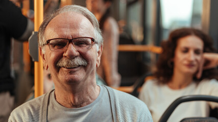 Close up of an older man sitting on a bus