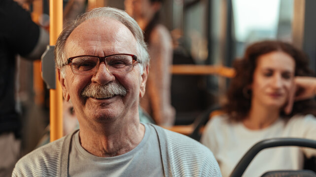 Close up of an older man sitting on a bus