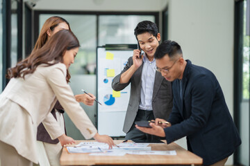 Group of businesspeople are standing in a meeting, exchanging knowledge in the office.
