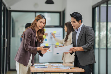 A group of Asian businessmen stood and discussed ways to solve investment business problems.
