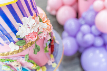 Birthday Cake at celebration party with balloons in background