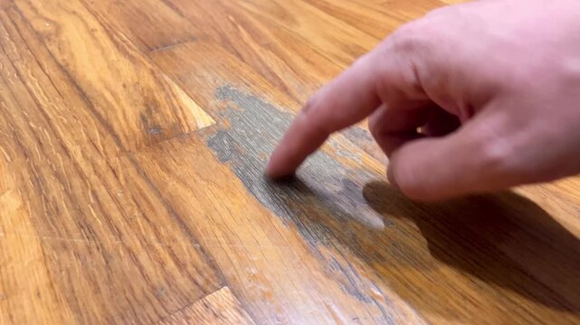 A wooden floor with a stain on it. The floor is made of wood