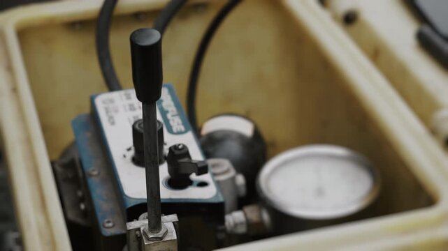 Close-up of the control lever of a pneumatic device. Industrial equipment controls.